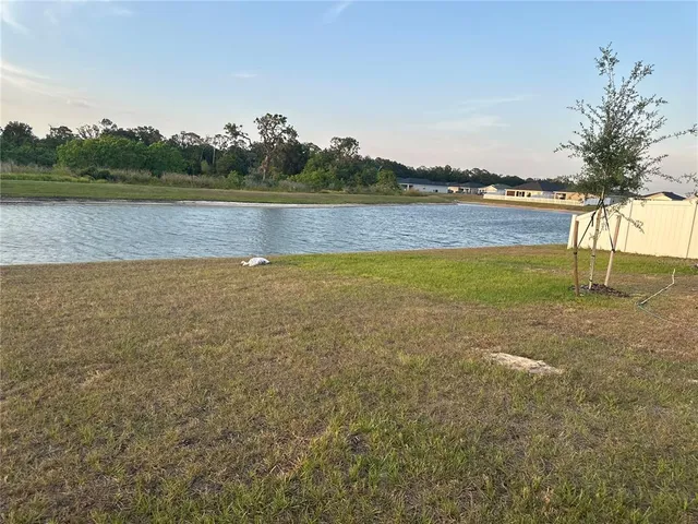 a view of a lake with houses in the back