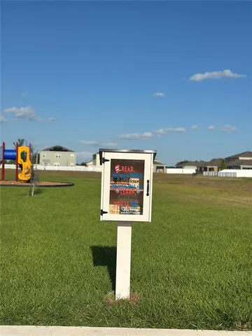 a view of a lake with table and chairs