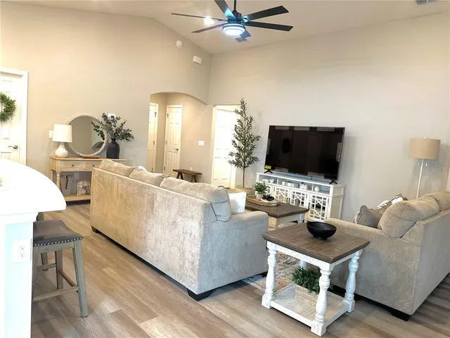 a living room with furniture and a flat screen tv