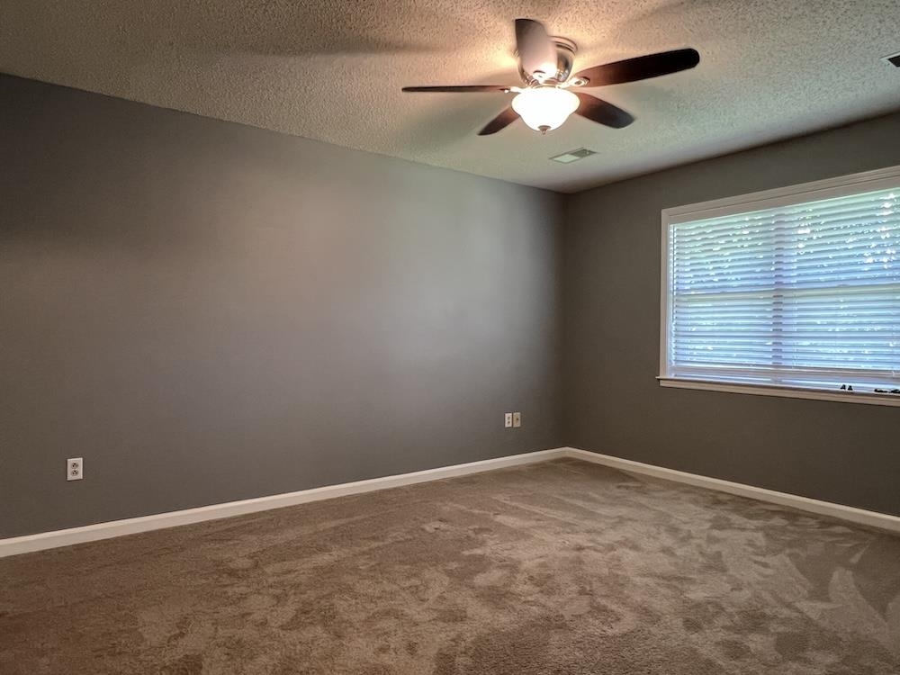 7935 Memphis Arlington Road Bartlett, TN 38133 - Photo 16 of 20 Carpeted room with a ceiling fan, a window with blinds, and neutral wall paint