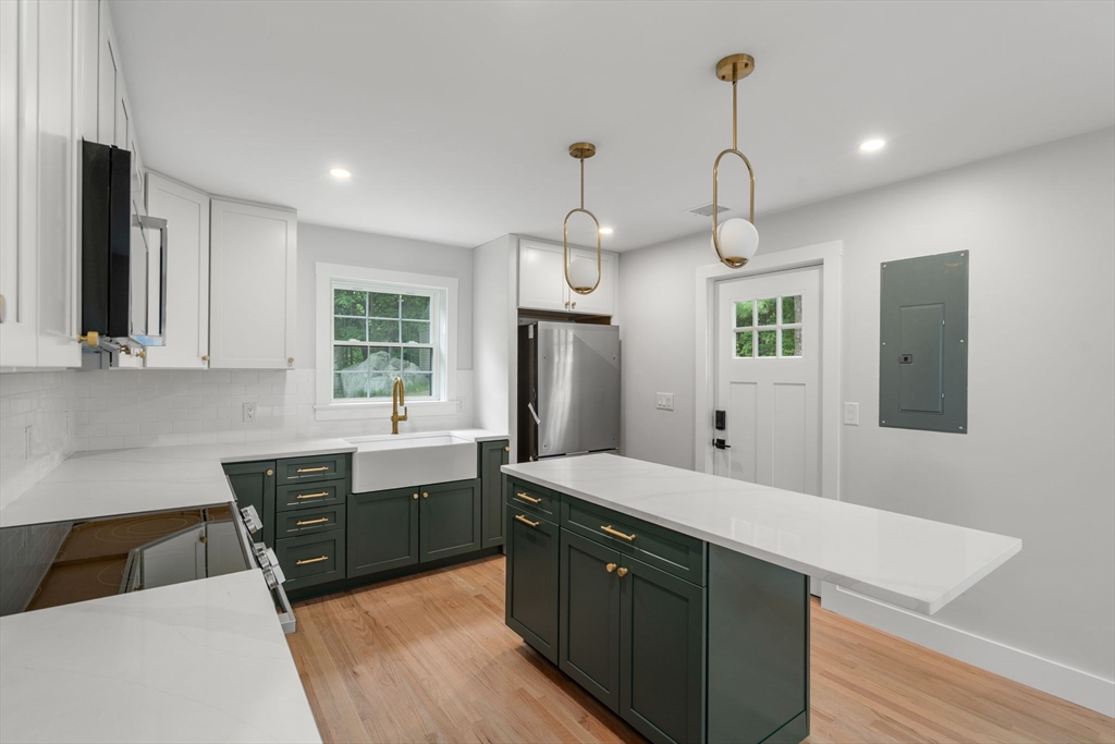 19 Whitehorse Road Hingham, MA 02043 - Photo 14 of 35 a large kitchen with granite countertop a sink counter space and stainless steel appliances