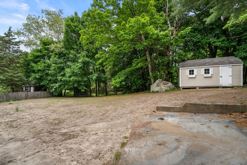 19 Whitehorse Road Hingham, MA 02043 - Photo 32 of 35 a backyard of a house with large trees and plants