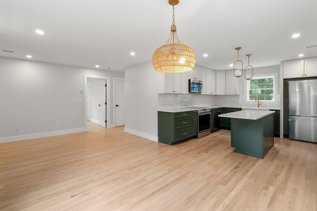 19 Whitehorse Road Hingham, MA 02043 - Photo 5 of 35 a large kitchen with stainless steel appliances granite countertop a sink a stove and a wooden floors