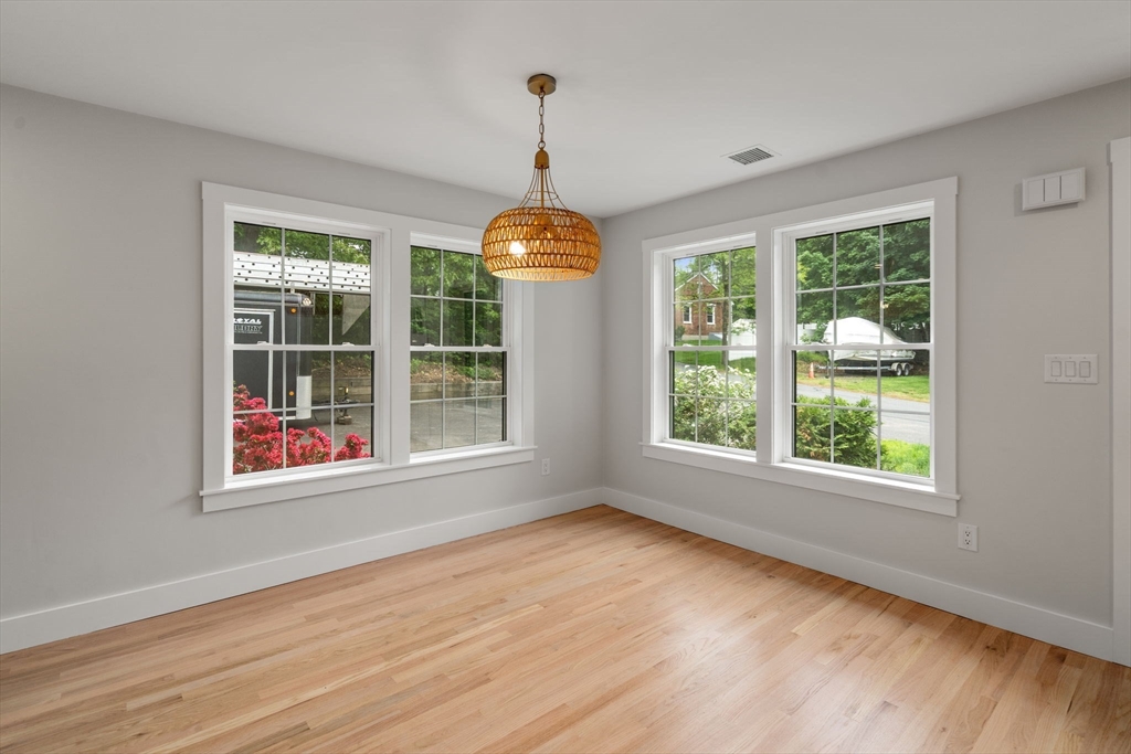 19 Whitehorse Road Hingham, MA 02043 - Photo 6 of 35 a view of an empty room with wooden floor and a window