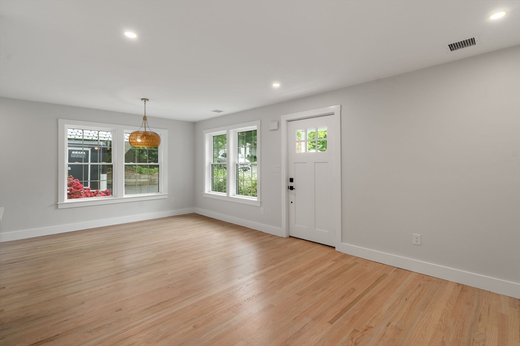 19 Whitehorse Road Hingham, MA 02043 - Photo 7 of 35 an empty room with wooden floor and windows