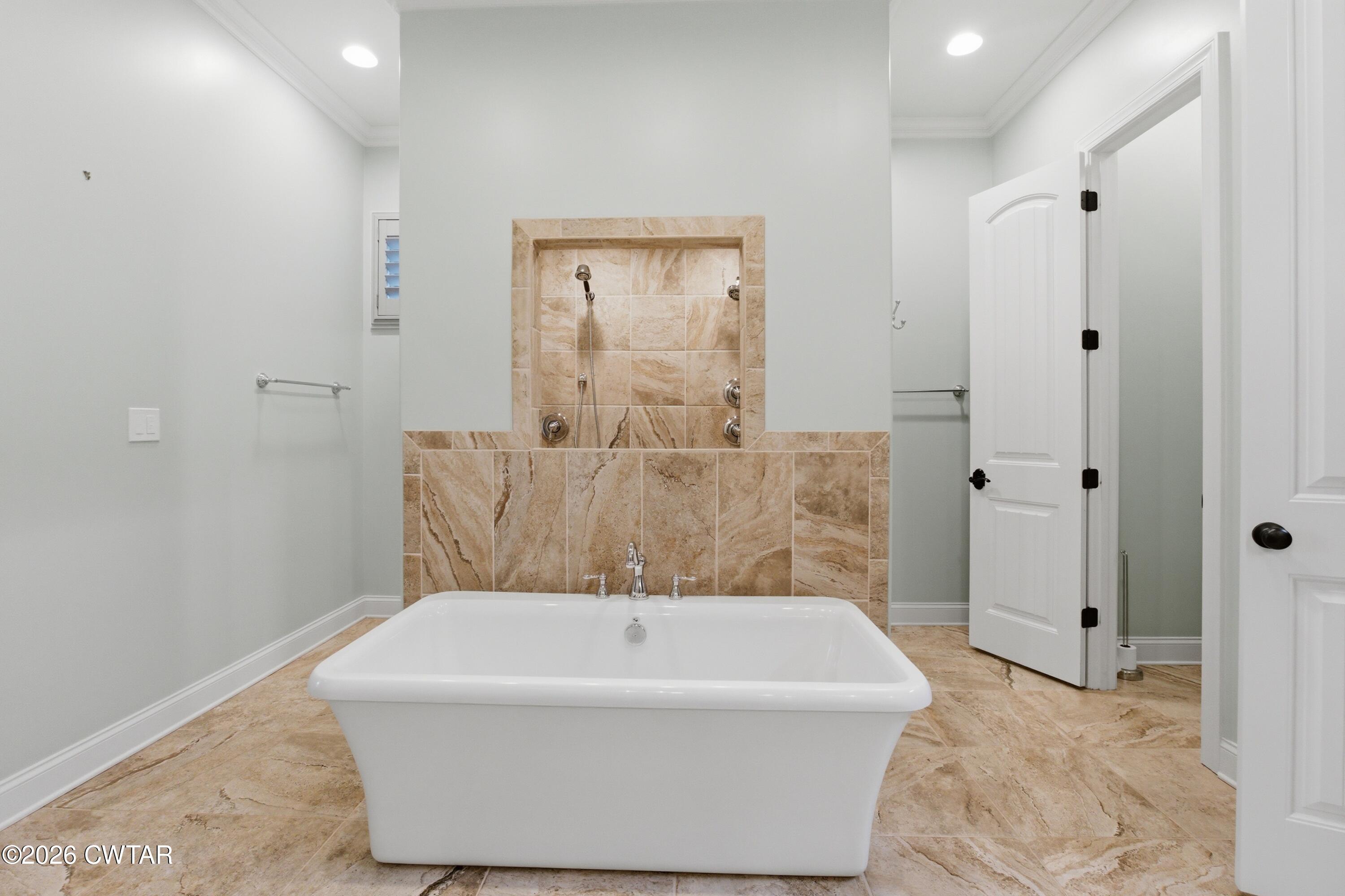 963 Ashport Road Jackson, TN 38305 - Photo 26 of 60 a bathroom with a bathtub and shower