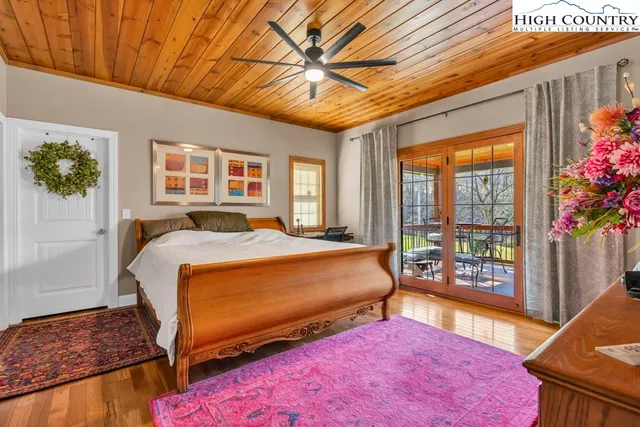 a bedroom with a bed and a potted plant