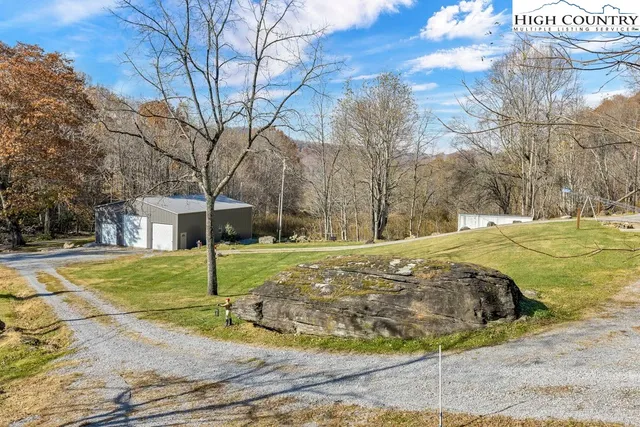 a view of a yard with wooden fence