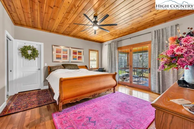 a bedroom with furniture and a large window