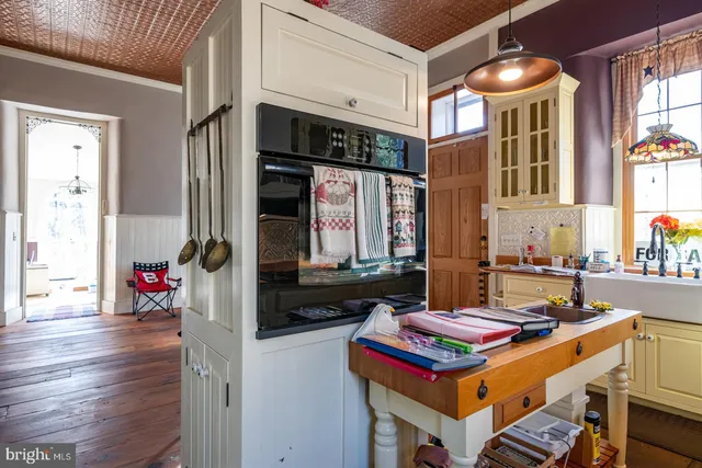 a living room with furniture a fireplace and a floor to ceiling window