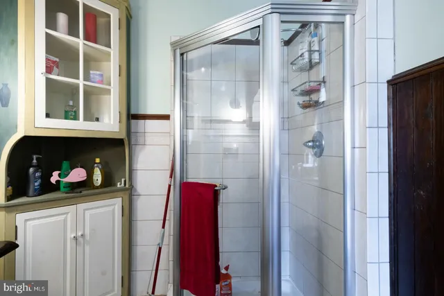 a hallway with wooden floor stairs and furniture