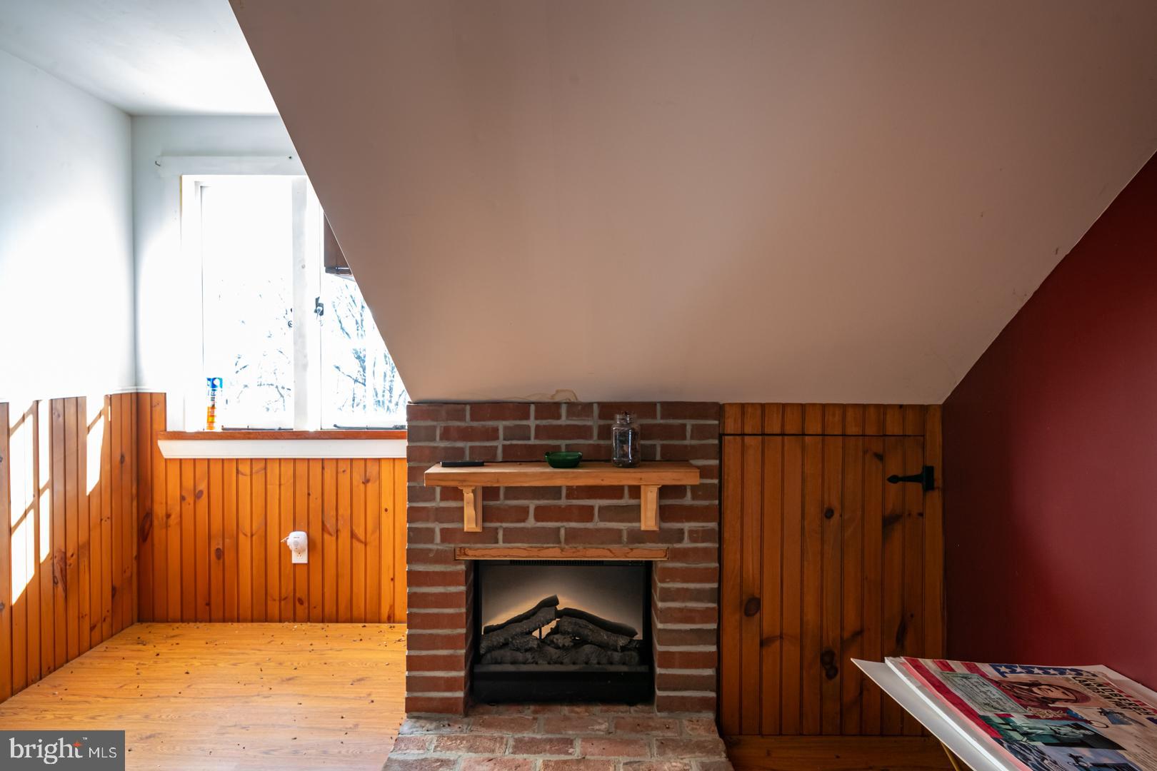 1192 Fritztown Road Reinholds, PA 17569 - Photo 28 of 36 a view of an empty room with wooden floor fireplace and a window