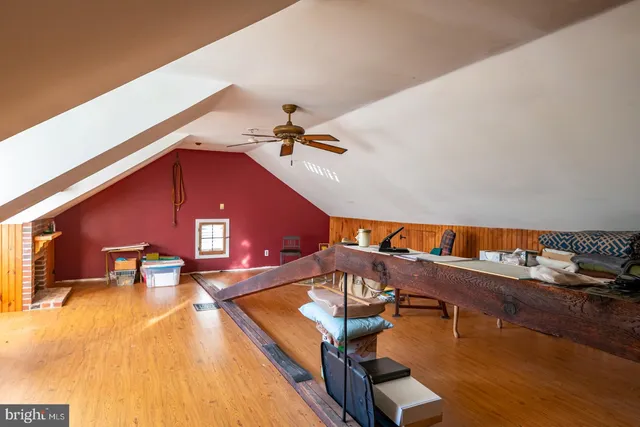 a view of a house with a yard and large trees