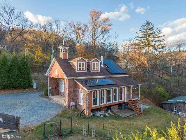 a view of a house with a yard deck and sitting area