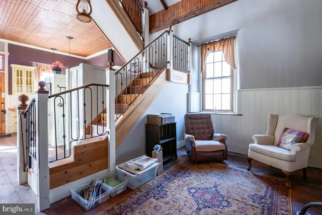 a living room with lots of furniture and book shelf