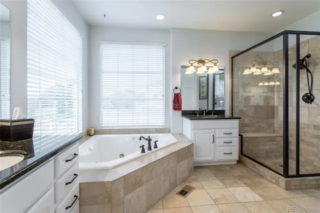 a bathroom with a bathtub sink and mirror