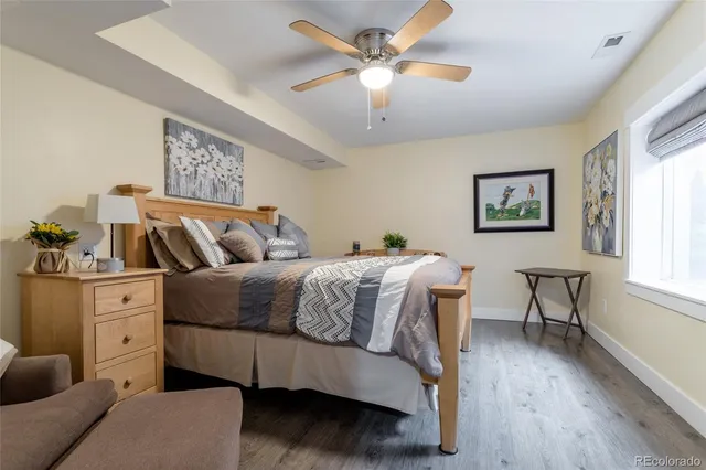 a bathroom with a granite countertop sink a mirror and a shower