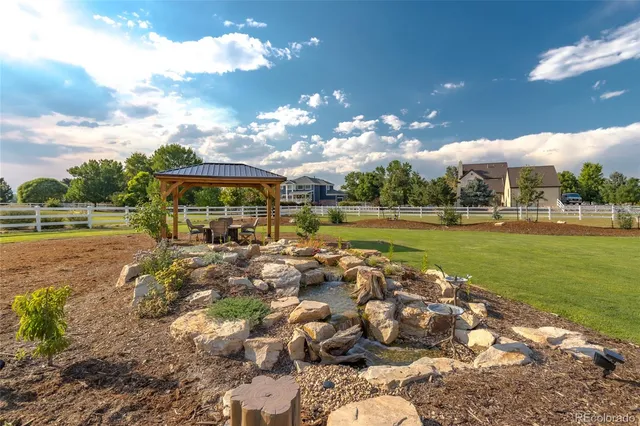 a front view of a house with swimming pool having outdoor seating