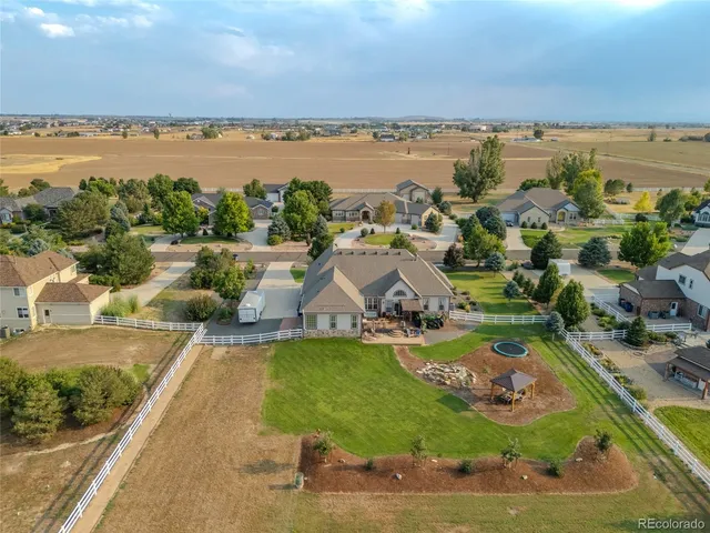 an aerial view of a house with swimming pool garden and patio