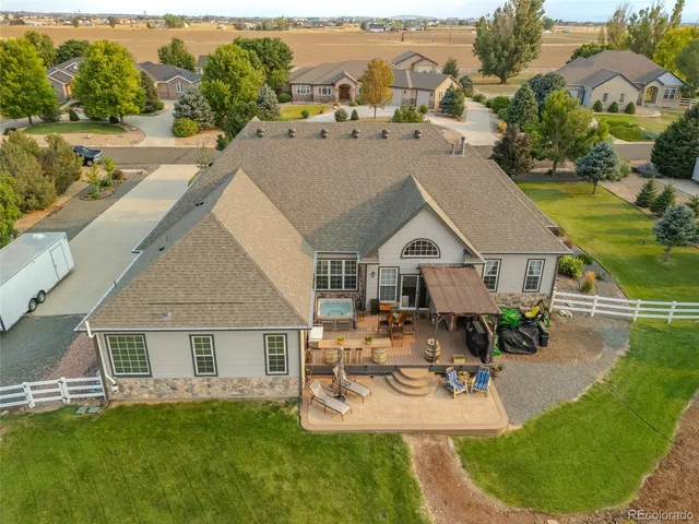 an aerial view of a residential houses with outdoor space and swimming pool