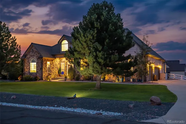 a view of a big house with a big yard and plants