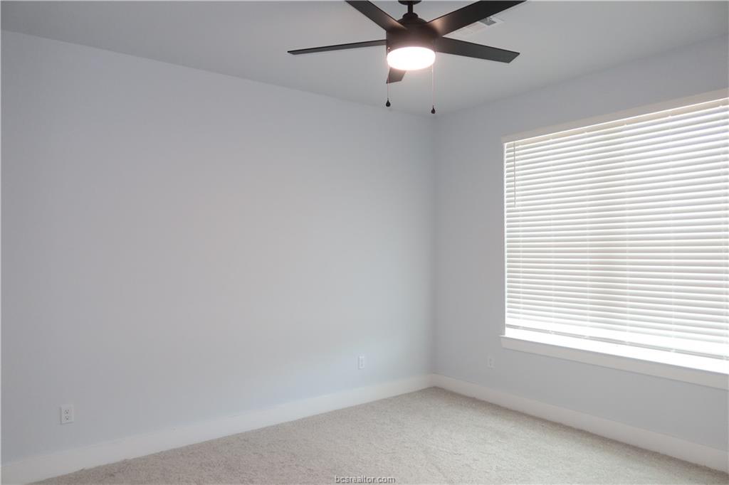 2004 Reagan Court Bryan, TX 77802 - Photo 11 of 19 an empty room with a window and a fan