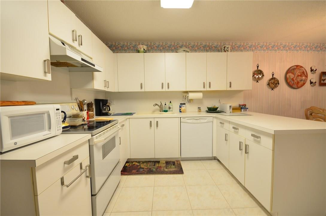 6761 Montego Bay Boulevard, Unit B Boca Raton, FL 33433 - Photo 12 of 34 a kitchen with a cabinets and white appliances