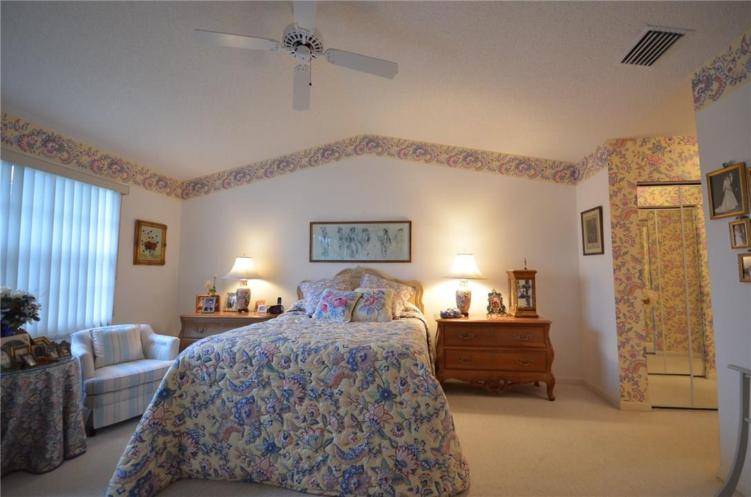6761 Montego Bay Boulevard, Unit B Boca Raton, FL 33433 - Photo 20 of 34 a bedroom with double bed and a couch