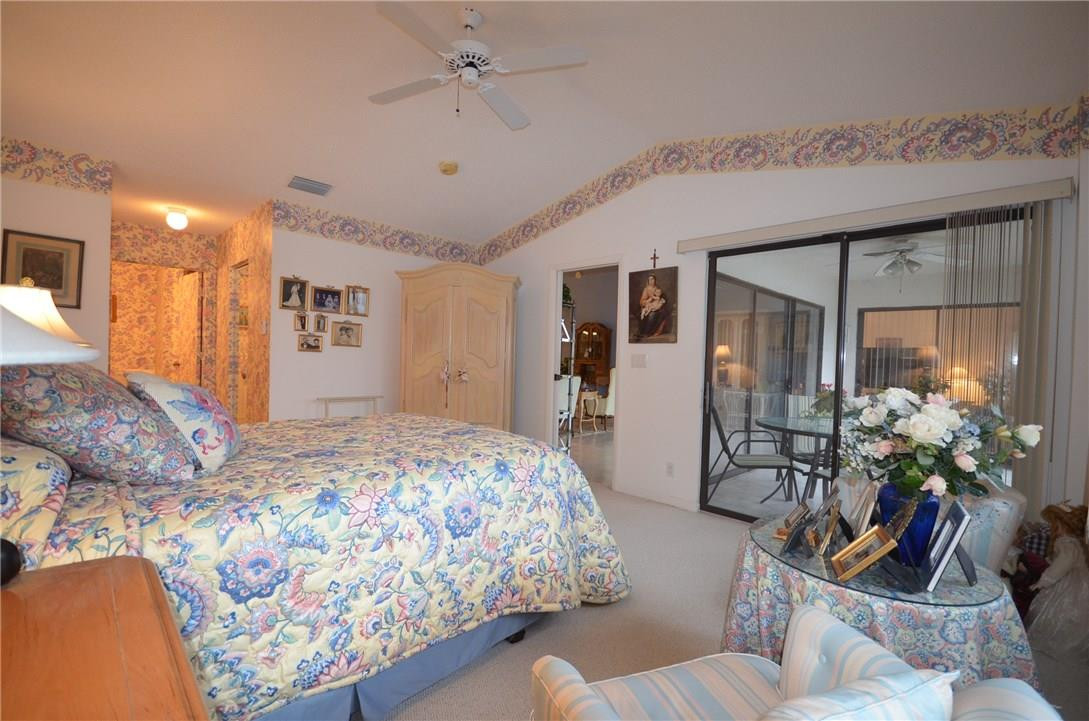 6761 Montego Bay Boulevard, Unit B Boca Raton, FL 33433 - Photo 22 of 34 a bedroom with bed and glass door