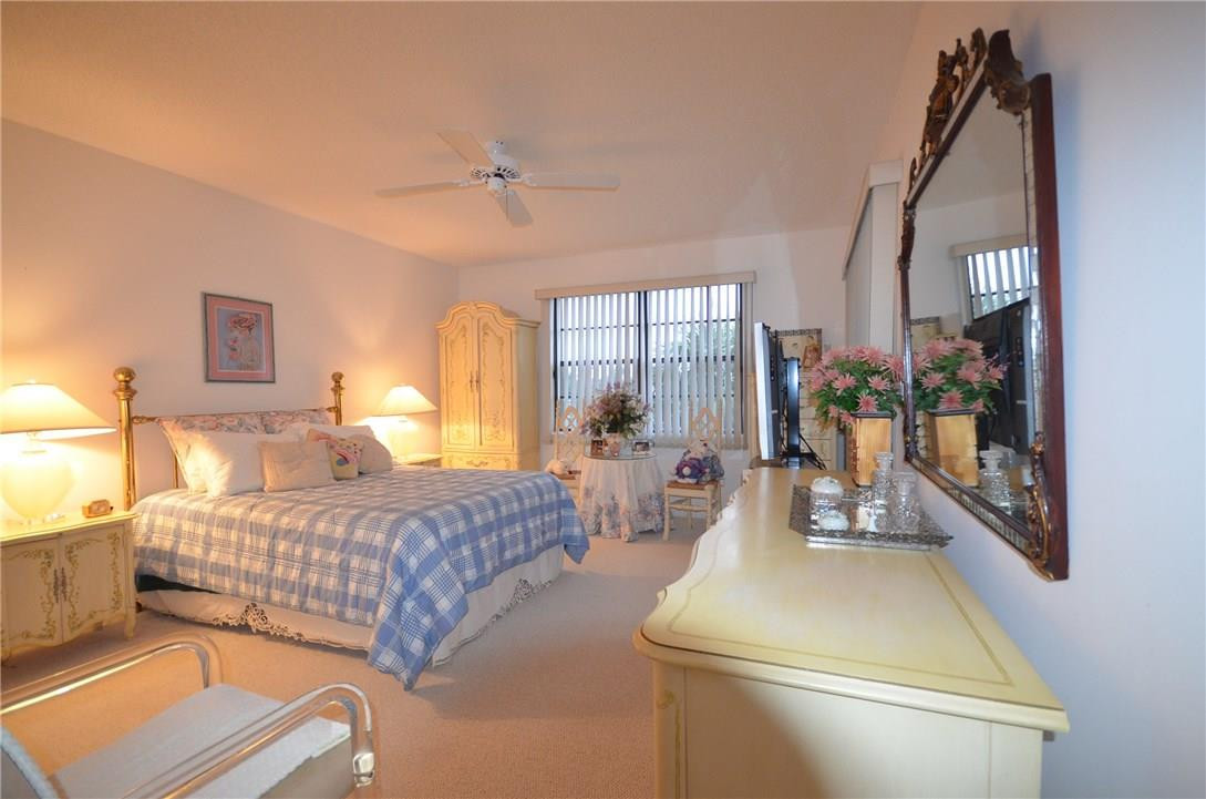 6761 Montego Bay Boulevard, Unit B Boca Raton, FL 33433 - Photo 26 of 34 a bedroom with a bed window and couch