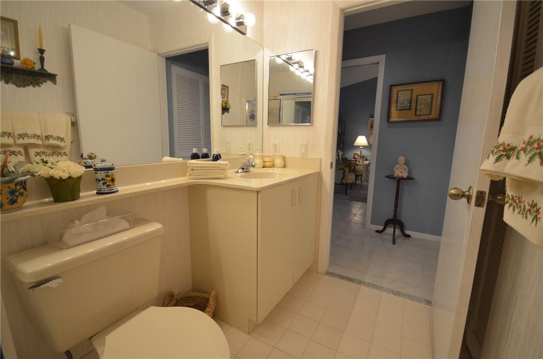 6761 Montego Bay Boulevard, Unit B Boca Raton, FL 33433 - Photo 29 of 34 a bathroom with a granite countertop sink mirror vanity and toilet