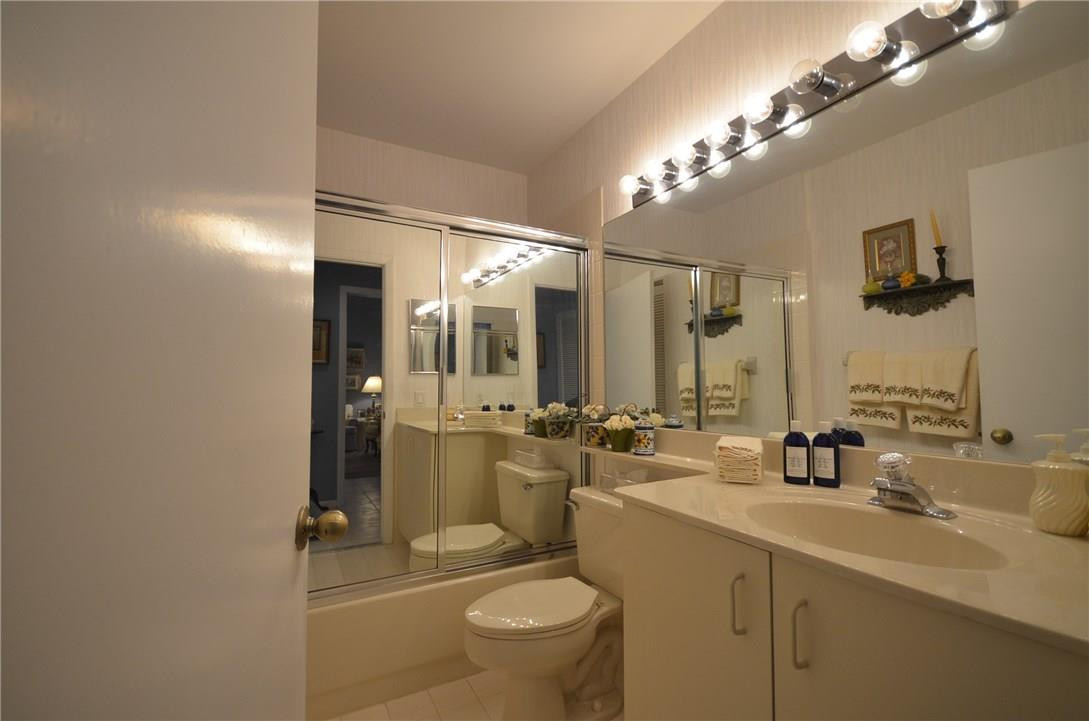 6761 Montego Bay Boulevard, Unit B Boca Raton, FL 33433 - Photo 30 of 34 a bathroom with a sink a toilet a mirror and shower