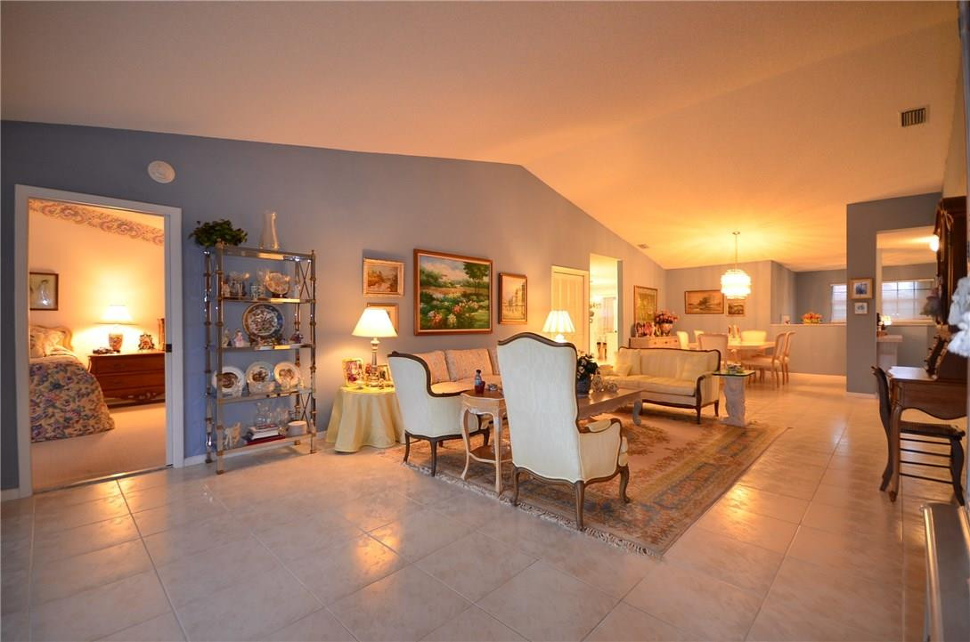 6761 Montego Bay Boulevard, Unit B Boca Raton, FL 33433 - Photo 3 of 34 a living room with furniture a dining table and chairs