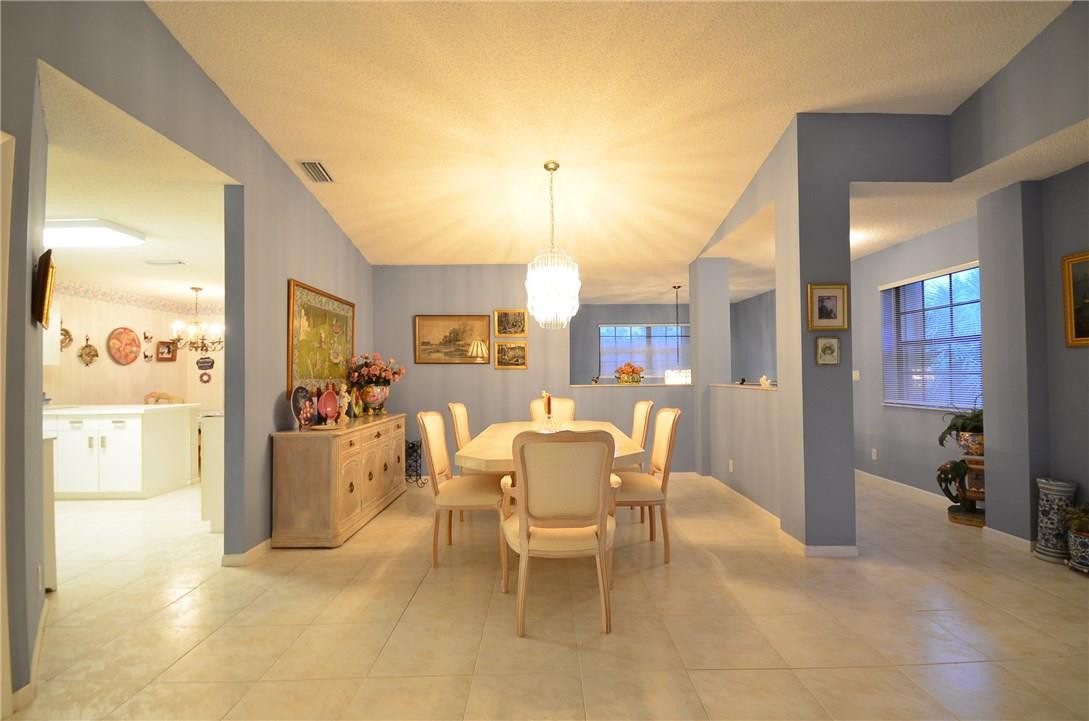 6761 Montego Bay Boulevard, Unit B Boca Raton, FL 33433 - Photo 5 of 34 a dining room with furniture and a chandelier