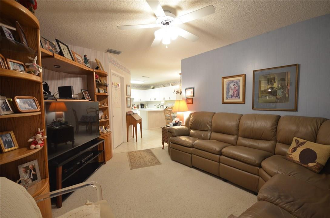 6761 Montego Bay Boulevard, Unit B Boca Raton, FL 33433 - Photo 6 of 34 a living room with furniture and a flat screen tv