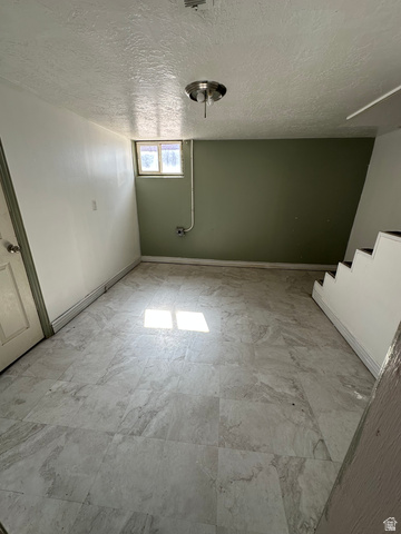 8320 West 3100th Street South Magna, UT 84044 - Photo 25 of 41 Below grade area featuring a textured ceiling and baseboards