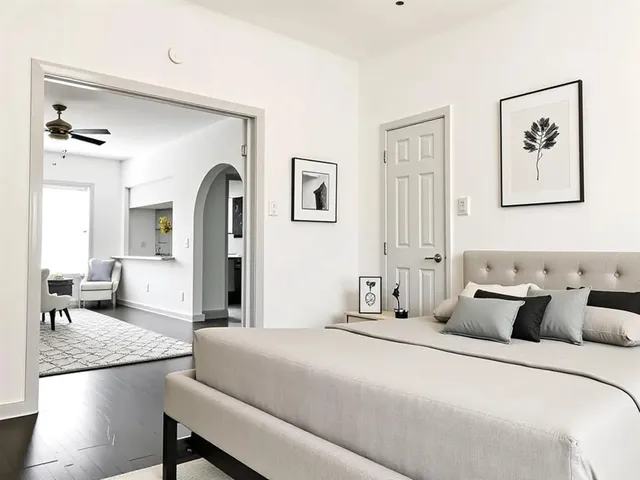 a bedroom with a bed and a chandelier