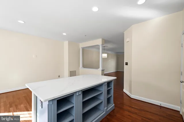 a kitchen with a sink stove cabinets and refrigerator