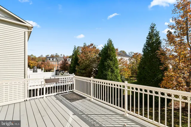 a view of balcony with wooden floor and fence