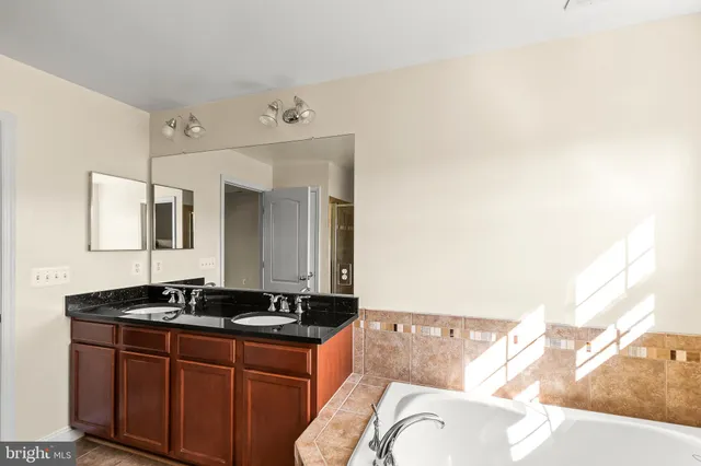 an empty room with floor to ceiling windows and fireplace