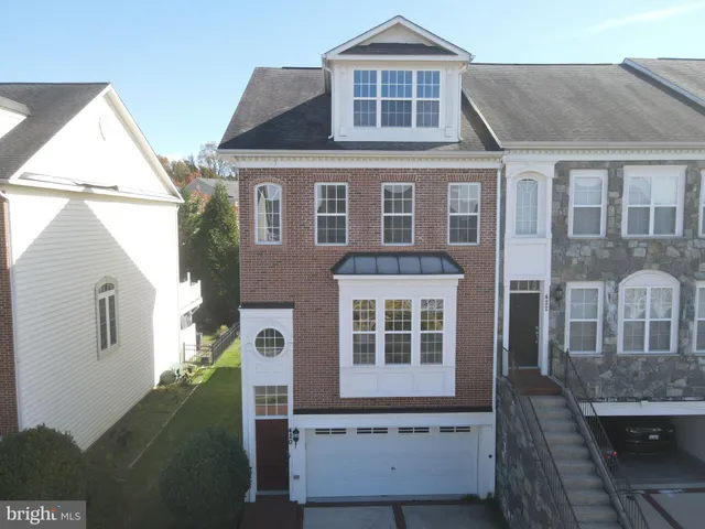 a front view of a house with lots of trees