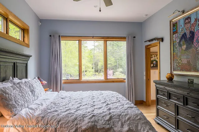 a bathroom with a granite countertop shower a sink and a mirror