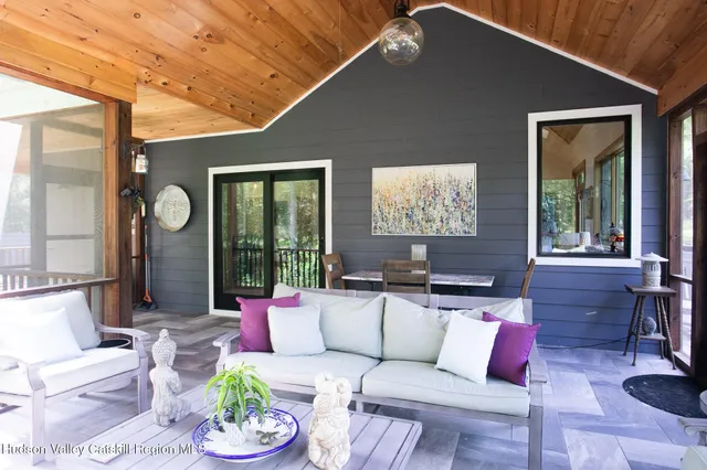 a view of a house with a yard and potted plants