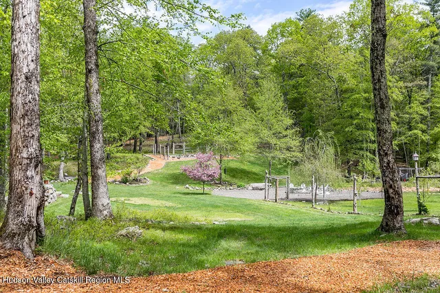 a view of a lush green forest with trees and some houses