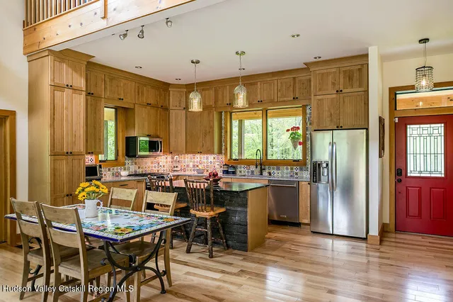 a kitchen with a sink stove and microwave