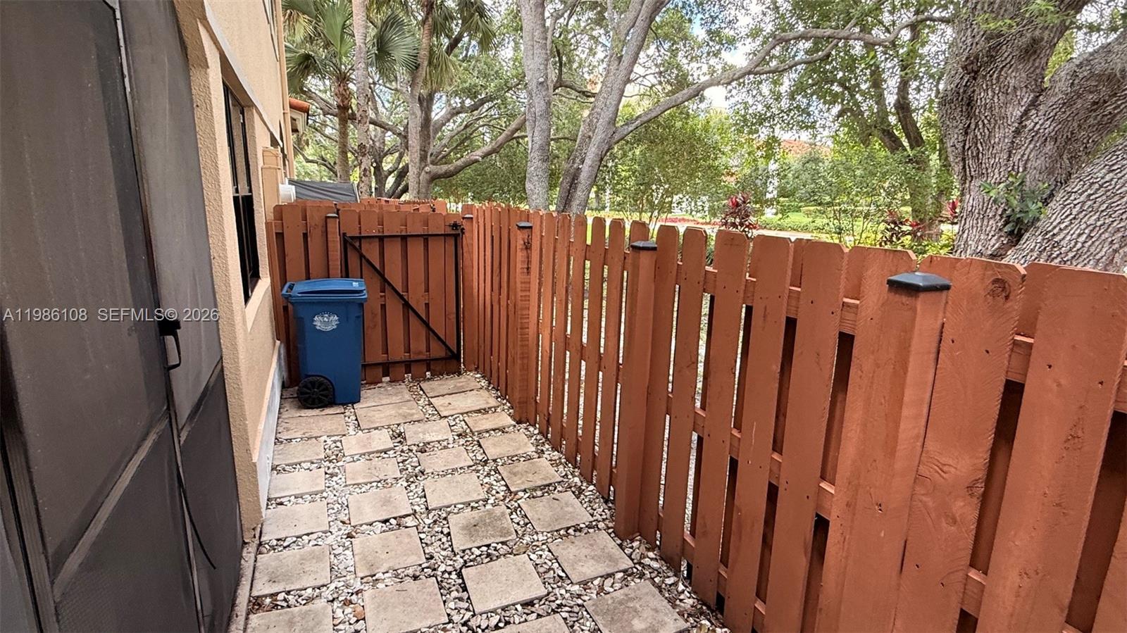 513 Racquet Club Road, Unit 55 Weston, FL 33326 - Photo 25 of 25 a view of a pathway of a house with wooden fence