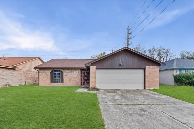 a front view of house with backyard and green space
