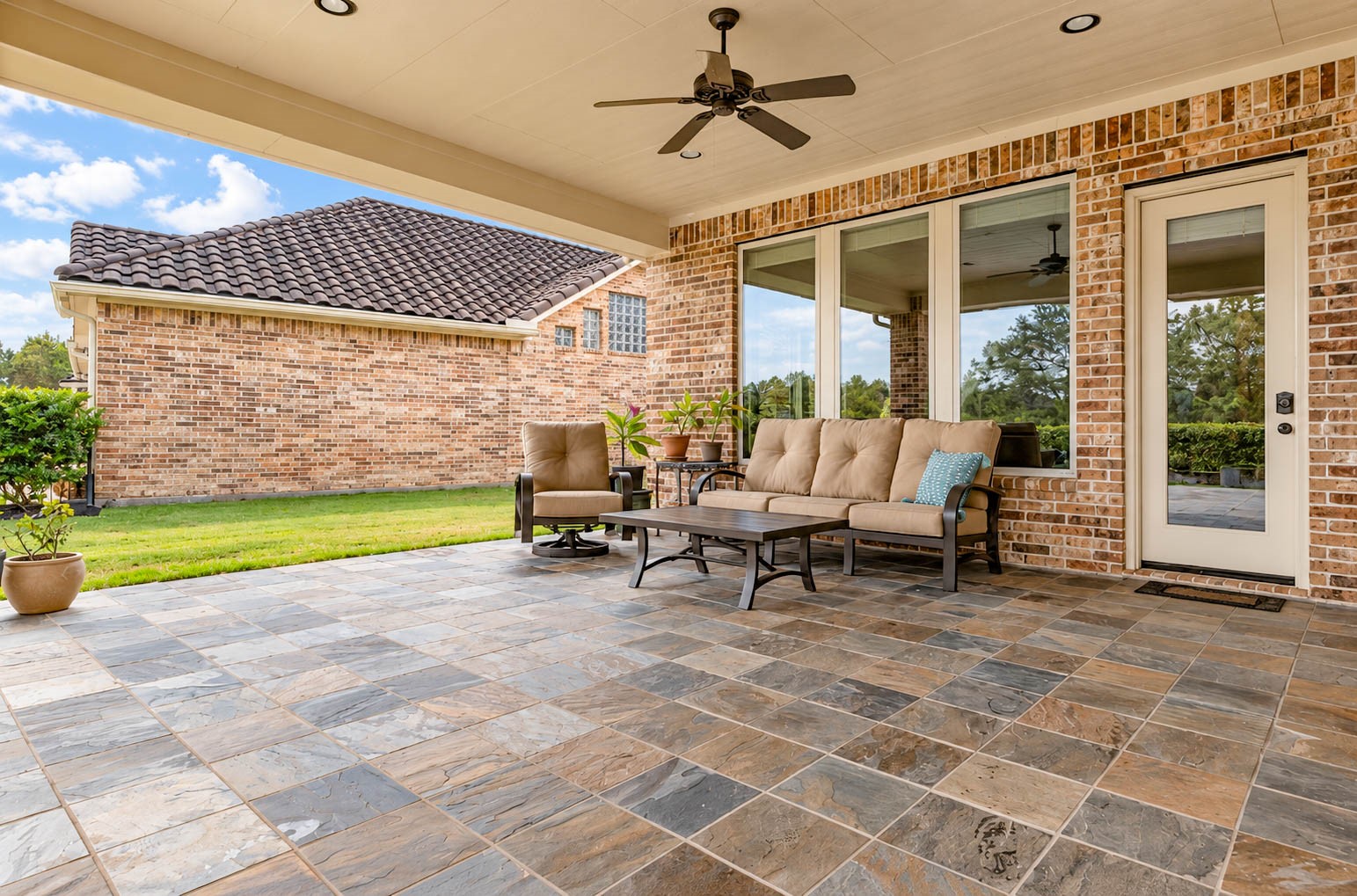 91 Lake View Loop Fulshear, TX 77441 - Photo 35 of 42 This covered patio offers plenty of room for your favorite outdoor seating, a dining table, and more, making it an ideal extension of the home for relaxing or entertaining.