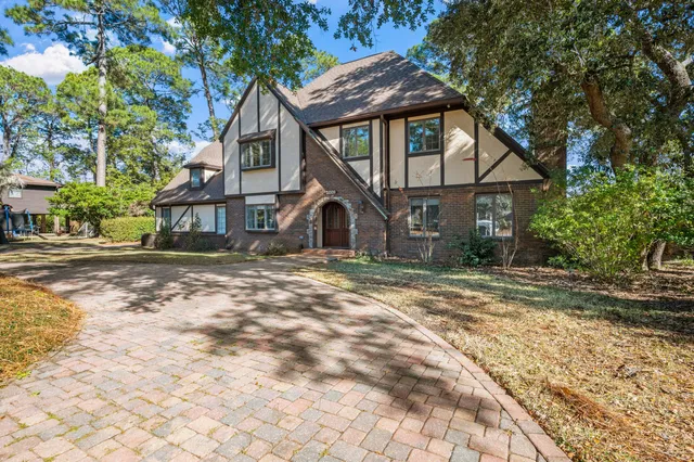 an empty room with windows and fireplace