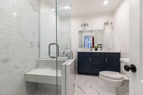 a bathroom with a sink a toilet and mirror